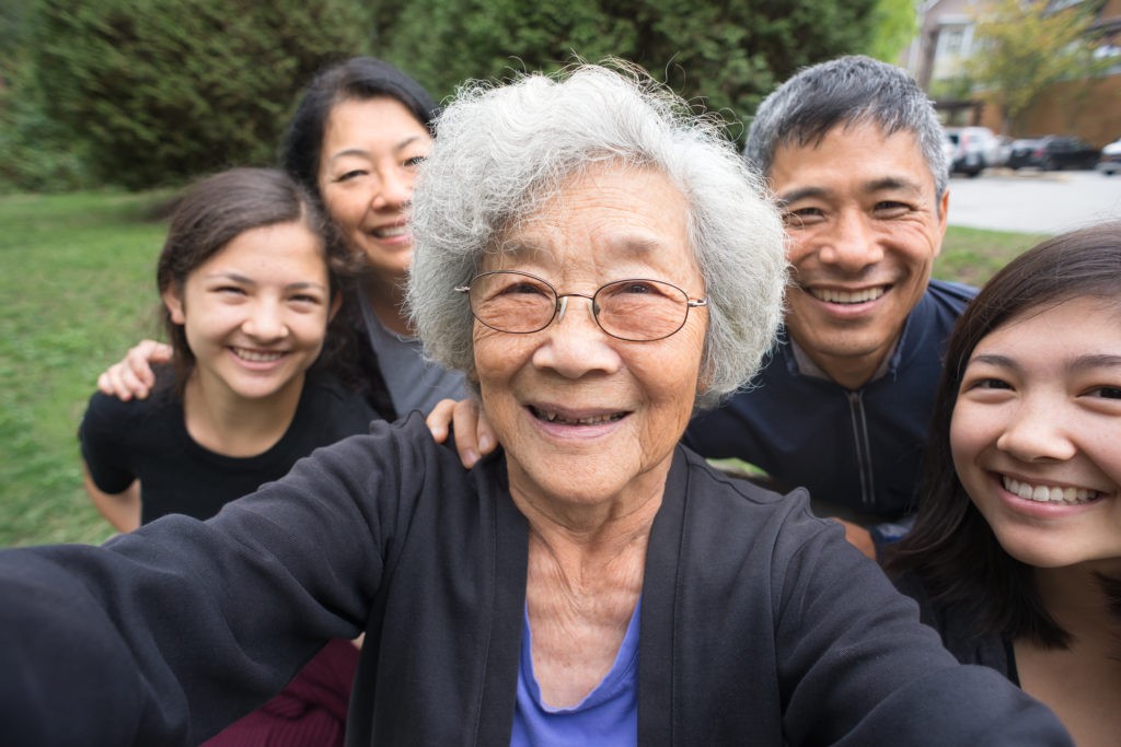 Grandmother, Children, Grandchildren Pose for Selfie, Care Home in Background